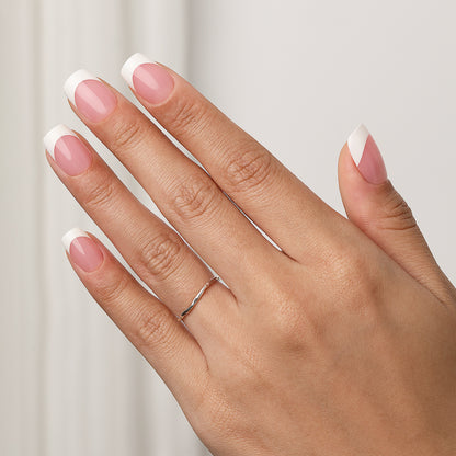 Short square press-on nails with a soft pink base and classic French tips